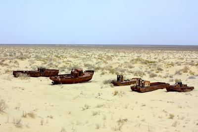 Abandoned boasts in dried-up Aral Sea.