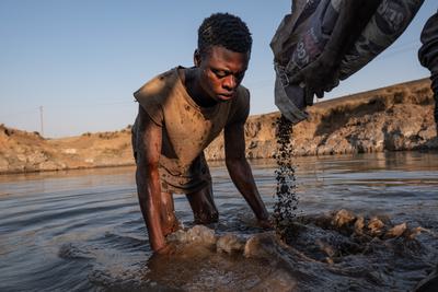 An artisanal miner pans for lead at the former Broken Hill mine in Kabwe.