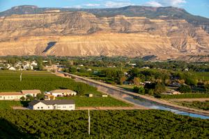 A canal managed by the Grand Valley Water Users Association carries water diverted from the Colorado River to peach orchards in Palisade, Colorado.