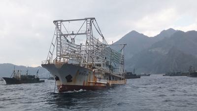 A Chinese fishing vessel, equipped with an array of lights to attract squid at night, anchored in South Korean waters.