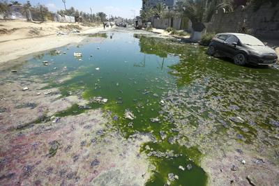 Raw sewage floods streets in Deir al Balah last July after treatment plants went out of service.