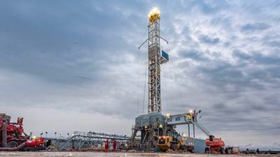 A drilling rig bores down more than 15,000 feet for a geothermal project in Beaver County, Utah.