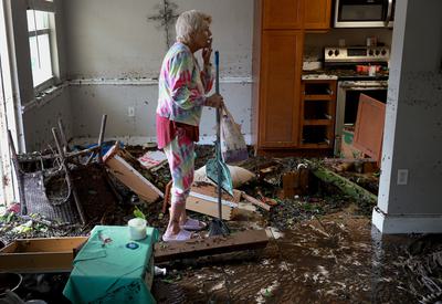 Fort Myers resident Stedi Scuderi surveys the damage to her home after Hurricane Ian, September 2022.