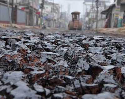 Workers lay down roadway made from plastic waste in Agartala, India, in January.
