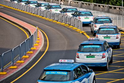 Electric taxis line up at a train station in Shenzhen, China in October, 2019.
