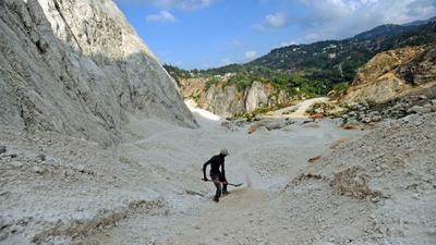 A worker collects sand at a mine near Port au Prince, Haiti in April 2014.