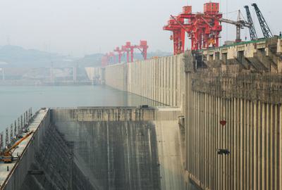 China's Three Gorges Dam, shown here under construction in 2006, is the world's largest. The corporation that built it now invests heavily in wind and solar energy.