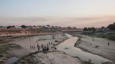 People in the northern Nigerian city of Maiduguri gather along the seasonal Ngadda River, which feeds into Lake Chad.