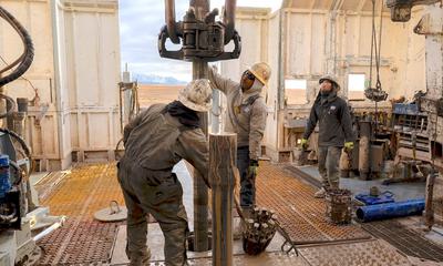 Workers prepare a drill at an enhanced geothermal project in Beaver County, Utah.