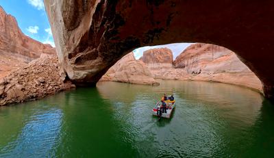 Boaters travel under Gregory Natural Bridge, in Lake Powell, which was under water until 2021.