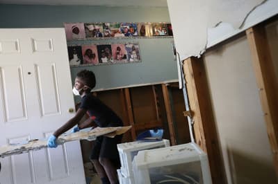 Kristopher Garner helps clean up the damage to his grandmother's property in Houston, Texas following Tropical Storm Harvey.