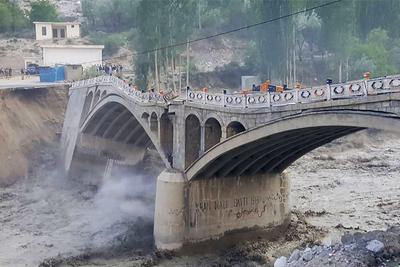 Flash floods caused by a glacial lake outburst destroy a bridge in Hassanabad, Gilgit-Baltistan Province, in 2022.