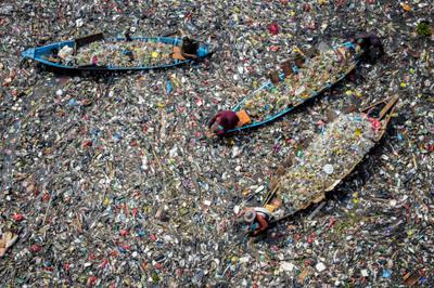 People collect plastic waste from the Citarum River in Indonesia.