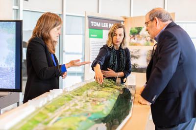 Orff (center) looks over a model of Tom Lee Park in Memphis.