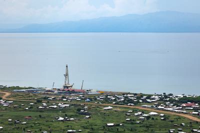 A drilling rig in the Kingfisher oil field sits on the shore of Lake Albert in Kikuube, Uganda.