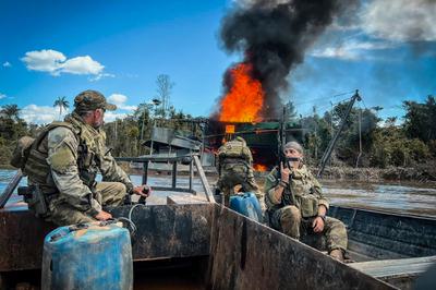 Federal agents destroy an illegal mining barge in Indigenous Yanomami territory in the Amazon.