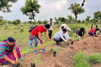 Locals plant native grasses at a restoration site in the village of Gulunche.