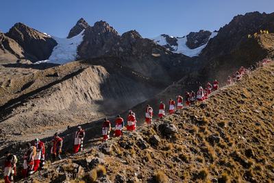 Indigenous people return from their pilgrimage to the Qulqipunku glacier.