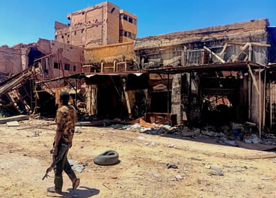 A fighter loyal to the Sudanese army patrols Khartoum.