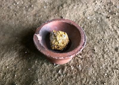 Left: Mercury is poured by miners on a clump of earth to amalgamate gold particles. Right: A lump of gold and mercury.