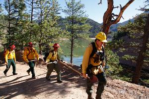 A fire crew hikes past McClure Reservoir in New Mexico en route to conducting a prescribed burn.